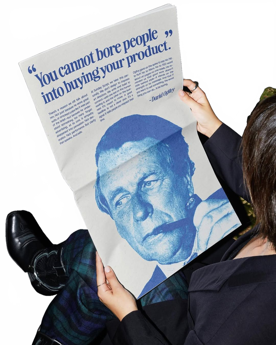 A reader holding a newspaper page headlined: you cannot bore people into buying your product.